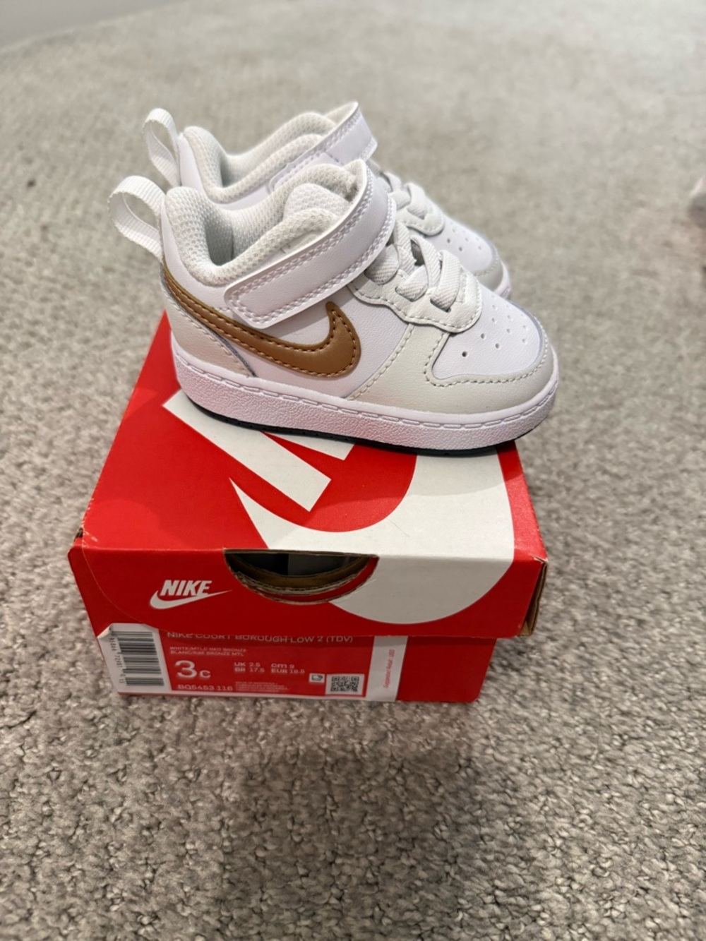Nike Kids White Sneakers with Gold Swoosh
